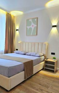 a bedroom with a large bed in a room at Жк "AUEZOV" in Kokshetau
