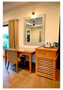 a dining room table with a mirror and a sink at Dream Habitat Resort in Mohurli +14 photos
