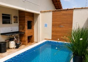 a swimming pool in the middle of a house at Beach House 96 in Itanhaém