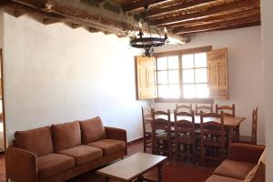 a living room with a couch and a table at El Rincón de Muñoz - La Alpujarra in Yegen