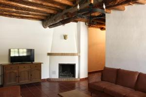 a living room with a couch and a fireplace at El Rincón de Muñoz - La Alpujarra in Yegen