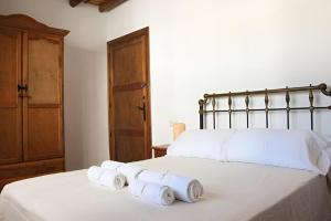 two rolls of towels sitting on top of a bed at El Rincón de Muñoz - La Alpujarra in Yegen
