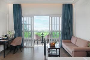 a living room with a couch and a table at The Haven by Sula in Nashik +29 photos