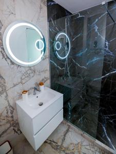 a bathroom with a white sink and a mirror at Nibiru Sea View in Costinesti +23 photos