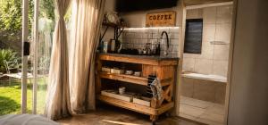 a bathroom with a sink and a bath tub at Rose cottage Garden Suite in Pretoria +27 photos