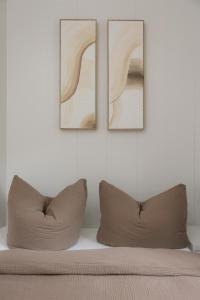 a bed with three pictures on a white wall at Hygge Tiny House 2 - Berlin Brandenburg in Berlin