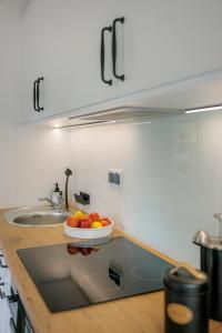 a bowl of fruit on a counter in a kitchen at Hygge Tiny House 2 - Berlin Brandenburg in Berlin