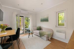 a living room with a couch and a table at Hygge Tiny House 2 - Berlin Brandenburg in Berlin
