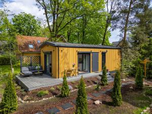 a yellow tiny house in a garden at Hygge Tiny House 2 - Berlin Brandenburg in Berlin