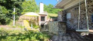 a patio with a yellow chair and an umbrella at Olive Gardens Cottage above Portorož in Strunjan +17 photos
