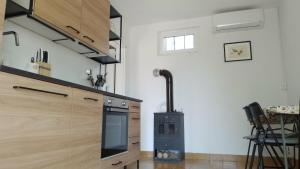a kitchen with a stove top oven in a room at Olive Gardens Cottage above Portorož in Strunjan