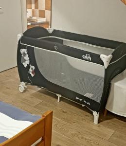 a black crib in a room with a bed at Maslenica-Bougainvillea in Maslenica