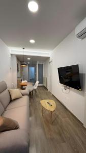 a living room with a couch and a tv on a wall at Rincón Mudejar in Teruel