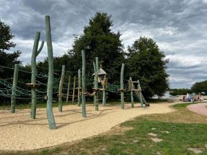 a park with a playground with a swing at Villa Seeblick am Fleesensee in Göhren-Lebbin