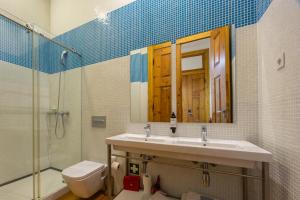 a bathroom with a sink and a toilet and a shower at Casa da Praça by PURUS in Coimbra +25 photos