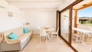 a living room with a couch and a table at Rena Bianca Residence 225 in Baja Sardinia