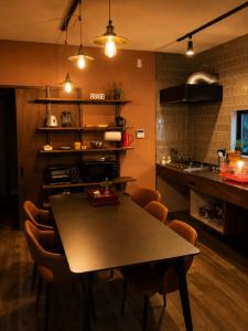 a kitchen with a table and chairs in a kitchen at Dar Sahha in Nara