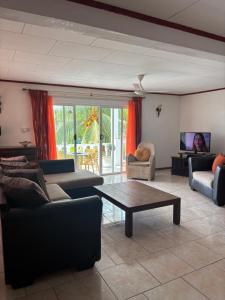 a living room with couches and a coffee table at Touchdown Villa in Pointe Larue