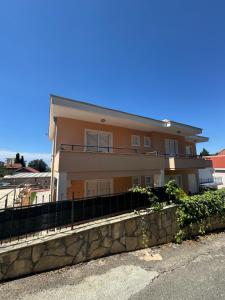 a house with a fence in front of it at SS Pearl Apartment in Utjeha
