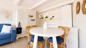 a dining room with a white table and chairs at Rena Bianca Residence 241 in Arzachena