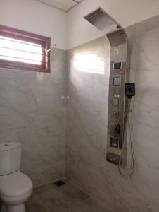 a bathroom with a shower and a toilet at Villa Aloe Vera- Signature Rooms in Weligama