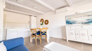a living room with a blue couch and a table at Rena Bianca Residence 241 in Arzachena