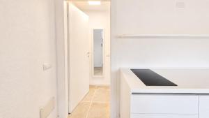 a kitchen with a white counter and a hallway at Rena Bianca Residence 241 in Arzachena +7 photos