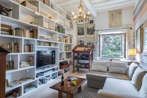 a living room with white bookshelves at ANTICA VILLA MERELLI 12, Emma Villas in Monte San Savino