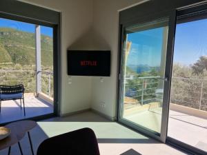 a room with sliding glass doors with a view of a balcony at Villa Maya Lefkada in Évyiros +94 photos