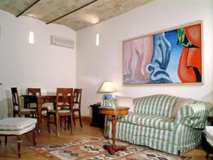 a living room with a couch and a table at Borgo Storico Seghetti Panichi in Castel di Lama