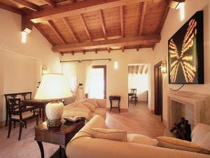 a living room with a couch and a fireplace at Borgo Storico Seghetti Panichi in Castel di Lama