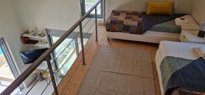 a small room with a bed and a glass staircase at Villa Maya Lefkada in Évyiros