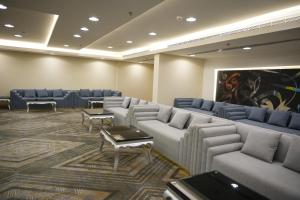 a waiting room with couches and chairs and a painting at Grand Plaza Hotel - Gulf Riyadh in Riyadh +156 photos