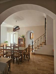 a dining room with a table and chairs and a staircase at La Bohème in Antequera +9 photos