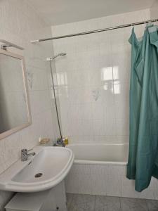 a bathroom with a sink and a bath tub at La Bohème in Antequera