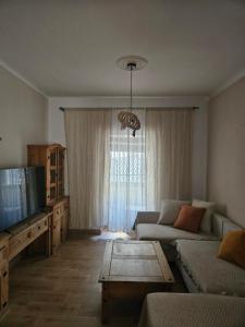 a living room with a couch and a tv at La Bohème in Antequera