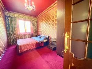 a bedroom with a bed and a window and a chandelier at Aladdin apartment in Kharkiv