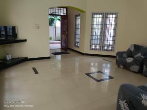 a living room with a lobby with couches at Green Haven Villas in Chennai +2 photos