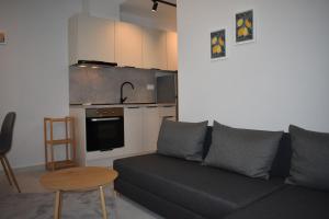 a living room with a couch and a kitchen at Lavandula in Xanthi