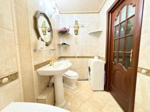 a bathroom with a sink and a toilet and a mirror at Aladdin apartment in Kharkiv +8 photos