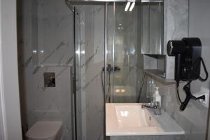 a bathroom with a shower and a sink and a toilet at Lavandula in Xanthi +15 photos