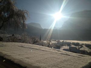 a sun is shining over a snow covered city at Apartment Marialis in Bizau
