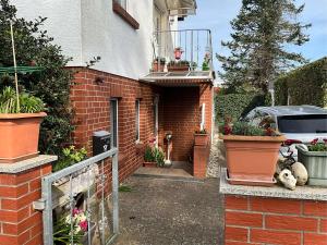 a brick entrance to a house with potted plants at Wolff, Jürgen in Graal-Müritz