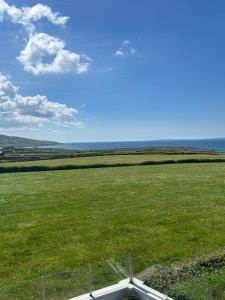 a field of green grass with the ocean in the background at Fanore Apartment 1 in Fanore