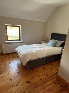 a bedroom with a large bed and a window at Fanore Apartment 1 in Fanore