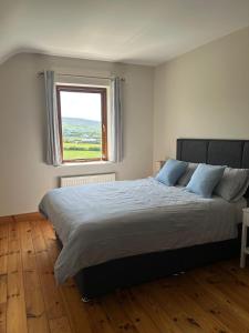 a bedroom with a large bed with a window at Fanore Apartment 1 in Fanore