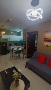 a living room with a couch and a table at Suite City view in Manila +10 photos