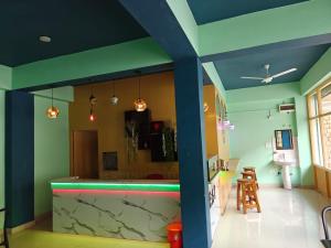 a kitchen with a bar in a room with blue walls at The Apricot Palace in Kargil