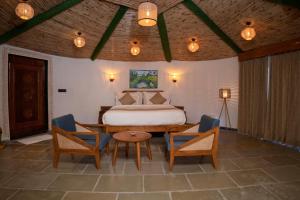 a bedroom with a bed and a table and chairs at Yadus By Alcor in Bīsalpur
