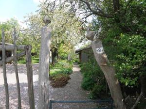 a wooden fence with a gate with a number on it at Ferienhaus Apfelhof in Tressow